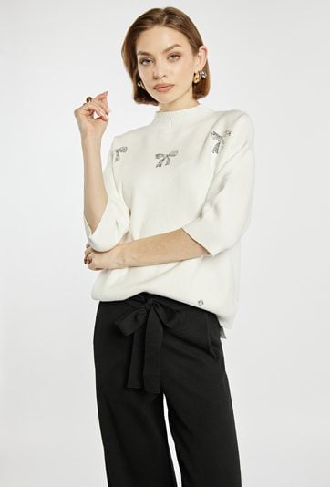 Sweter z błyszczącymi kokardkami