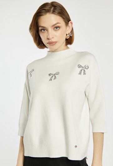 Sweter z błyszczącymi kokardkami