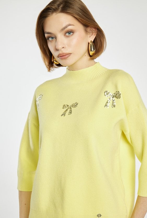 Sweter z błyszczącymi kokardkami