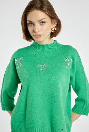 Sweter z błyszczącymi kokardkami