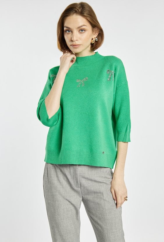 Sweter z błyszczącymi kokardkami