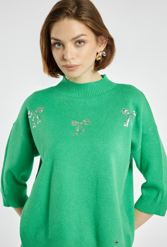 Sweter z błyszczącymi kokardkami