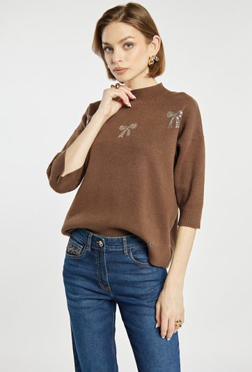 Sweter z błyszczącymi kokardkami