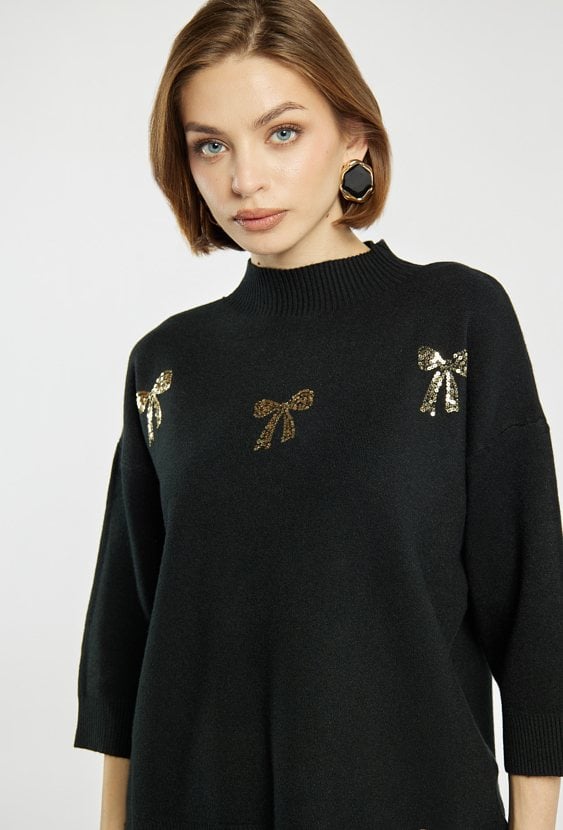 Sweter z błyszczącymi kokardkami