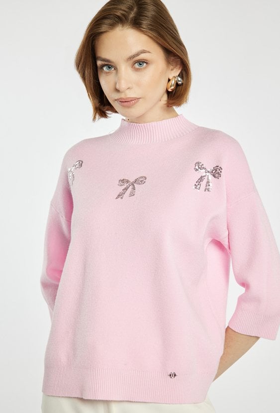 Sweter z błyszczącymi kokardkami